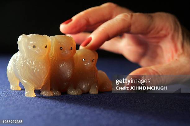 Gem-set grey chalcedony group of 3 Pekinese dogs by Faberge are seen at Christie's auction house in London, 28 November 2005. The dogs, circa 1890,...