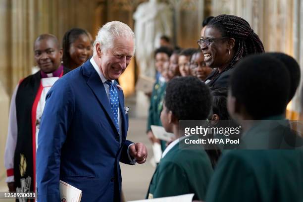 King Charles III speaks with guests following a service at St George's Chapel, Windsor Castle for young people, to recognise and celebrate the...
