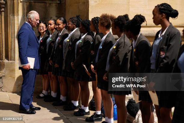 King Charles III meets with members of the choir from the St Martin-in-the-Fields High School for Girls, following a service at St George's Chapel,...