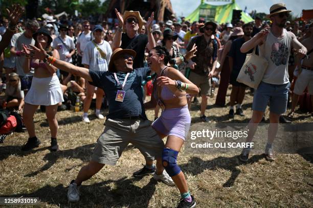 Festivalgoers have fun in the sun as they attend Day 2 of the Glastonbury festival in the village of Pilton in Somerset, southwest England, on June...