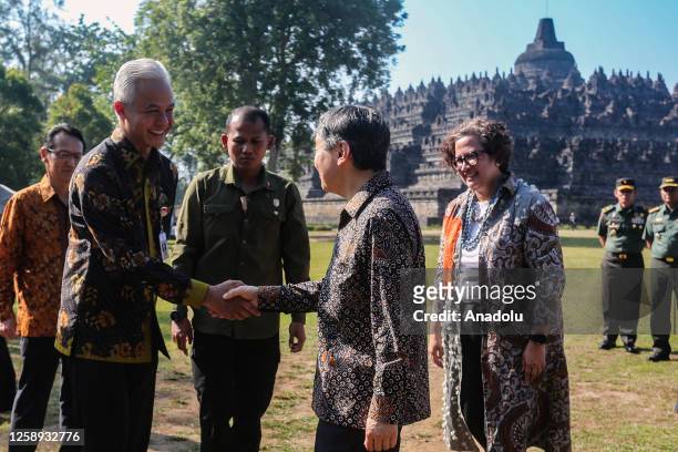 Japan's Emperor Naruhito shakes hands with Governor Central Java province Ganjar Pranowo during a visit to Borobudur Temple in Magelang, Central Java...