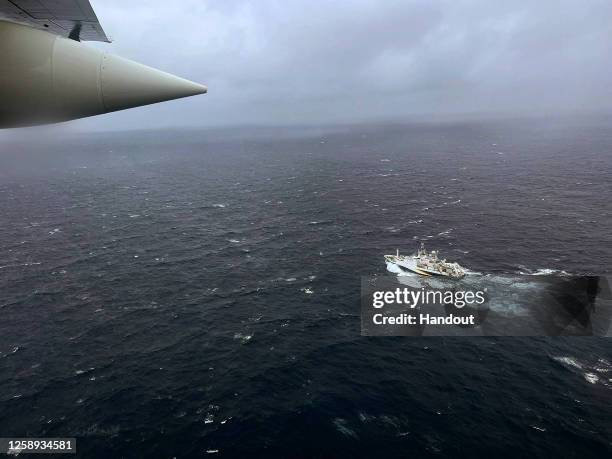 In this U.S. Coast Guard handout, a Coast Guard Air Station Elizabeth City, North Carolina HC-130 Hercules airplane flies over the French research...