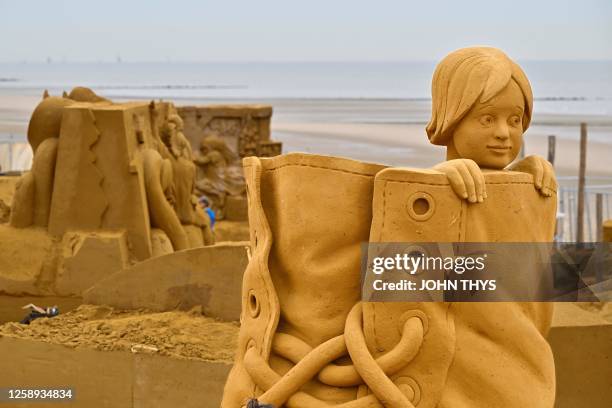 Sand sculpture representing figures in fairy tales is ready prior to the start of the Sand Sculpture Festival, in Middelkerke on June 22, 2023.