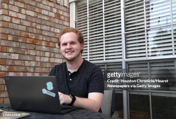 Zackary Pedersen of Snaju, works on his laptop as he is offering $25,000 worth of free websites to Houston small businesses to help them stay up and...
