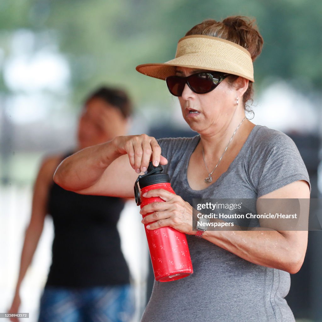 Edith Houston Edith Ramos gets water as she worked out in Rafael Rios's outdoor ...