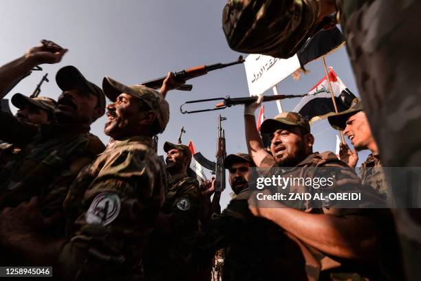 Fighters of the Hashed al-Shaabi, former paramilitaries integrated into the Iraqi forces, take part in a parade to mark the 9th anniversary of their...