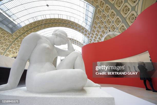 Woman looks at sculptures as she visits on March 9, 2009 at the Orsay Museum in Paris the exhibition, entitled "Oublier Rodin? La sculpture a Paris...