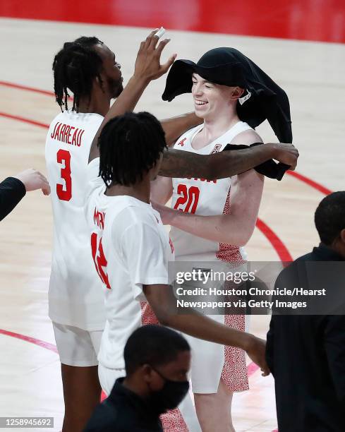 Houston Cougars guard Ryan Elvin is congratulated by DeJon Jarreau after he got a minute of playing time at the end of the Cougar's 76-50 win over...