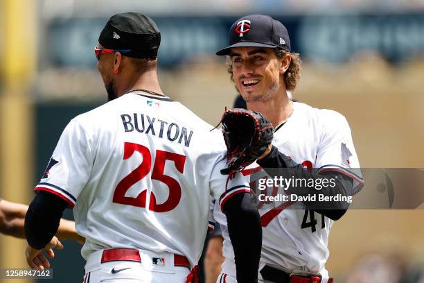 Joe Ryan of the Minnesota Twins celebrates his complete game shutout against the Boston Red Sox with teammate Byron Buxton after the game at Target...