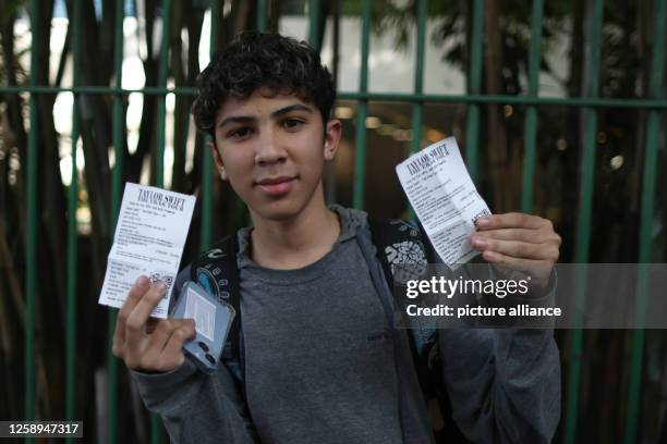 June 2023, Brazil, São Paulo: A boy shows the tikets just bought at the Allianz Parque stadium for "The Eras Tour" by Taylor Swift. After unrest...