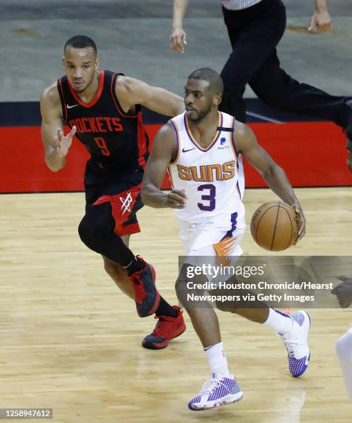 Phoenix Suns guard Chris Paul runs the ball against Houston Rockets guard Avery Bradley during the third quarter of an NBA basketball game at Toyota...