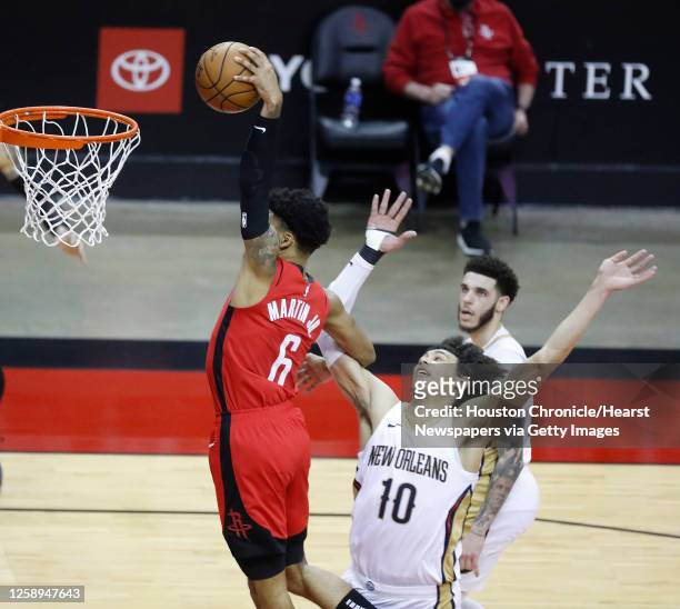 Houston Rockets forward Kenyon Martin Jr. Dunks the ball over New Orleans Pelicans center Jaxson Hayes during the second half of an NBA basketball...