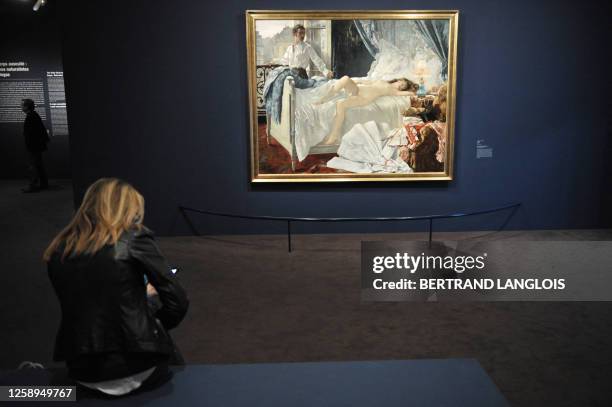 Woman looks at Rolla a painting by Henri Gervex during a visit of the "Degas and the Nude" exhibition at the Musee d'Orsay in Paris on March 12,...