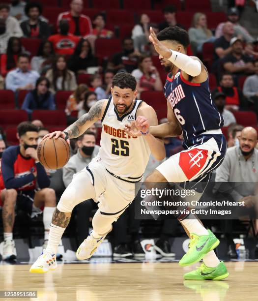 Denver Nuggets guard Austin Rivers works around Houston Rockets forward Kenyon Martin Jr. During the second half of an NBA basketball game at the...