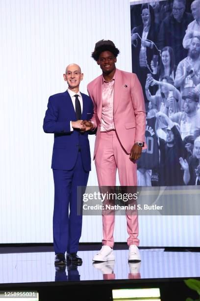 Taylor Hendricks shakes hands with NBA Commissioner Adam Silver after being selected number nine overall by the Utah Jazz during the 2023 NBA Draft...