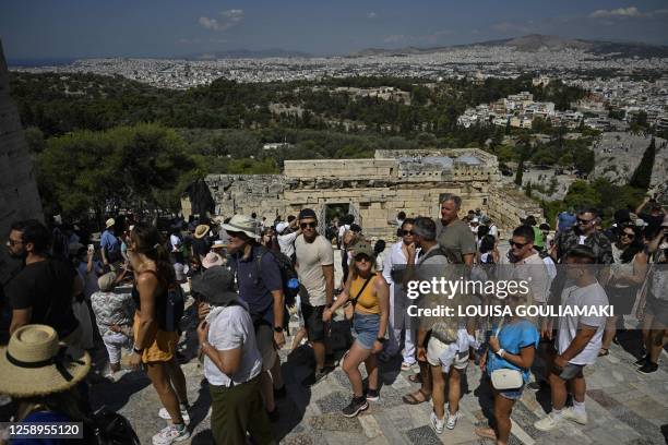 Tourists queue at Propylaia, the monument's ancient gate as they visit the Acropolis in Athens on June 14, 2023. "The wait and the amount of people...