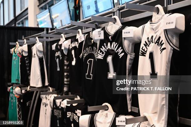 French basketball player Victor Wembanyama jerseys are displayed for sale in the team store after his selection as San Antonio Spurs's No. 1 pick...