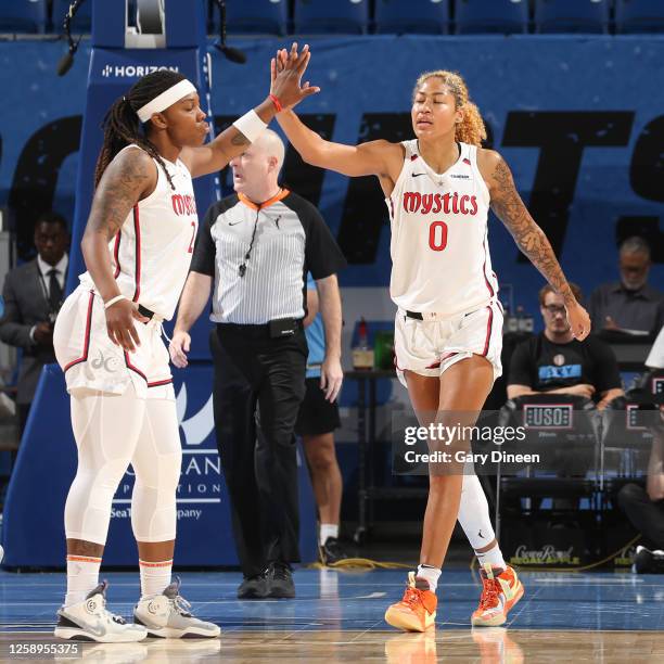 Myisha Hines-Allen and Shakira Austin of the Washington Mystics high five during the game against the Chicago Sky on June 22, 2023 at the Wintrust...