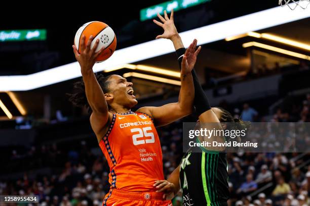 Alyssa Thomas of the Connecticut Sun goes up for a shot against Napheesa Collier of the Minnesota Lynx in the first quarter at Target Center on June...