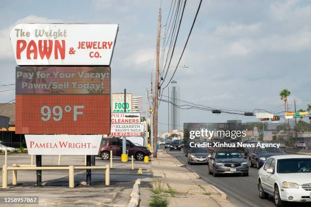 This photo taken on June 21, 2023 shows a temperature display reading 99 degrees Fahrenheit about 37.2 degrees Celsius in late afternoon in Houston,...