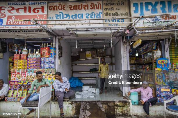 Shopkeeper sells slabs of ice to customers in Ahmedabad, Gujarat, India, on Friday, May 5, 2023. Ahmedabad is an example of the patchwork coping...