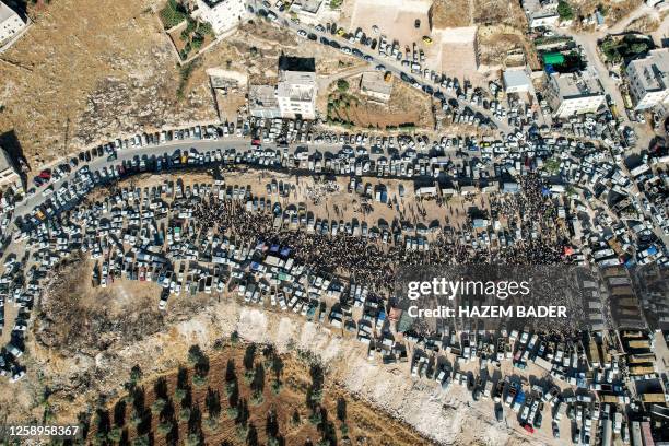This aerial view shows a livestock market in the occupied West Bank city of Hebron on June 23 as Palestinians prepare for the upcoming Muslim feast...