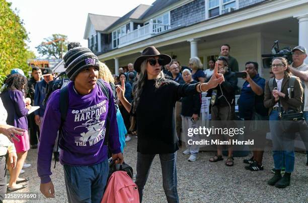 Venezuelan migrant is led onto a bus at St. Andrews Episcopal Church on Sept. 16 in Edgartown, Massachusetts, on the island of Martha&apos;s...