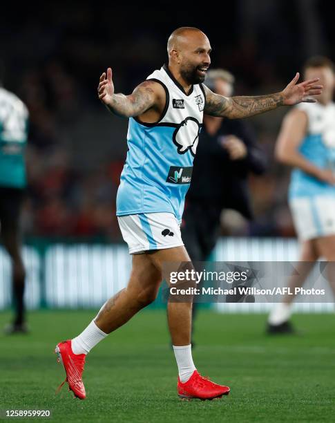 Archie Thompson celebrates as part of the Spud's Game Curtain Raiser during the 2023 AFL Round 15 match between the St Kilda Saints and the Brisbane...