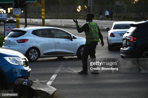 Self-appointed traffic controller directs traffic, to make money from driver tips, while traffic lights are down during a power shutdown, known...