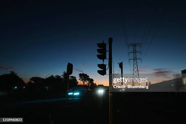 Nonfunctioning traffic lights on a darkened street during a power shutdown, known locally as loadshedding, in the evening in Johannesburg, South...