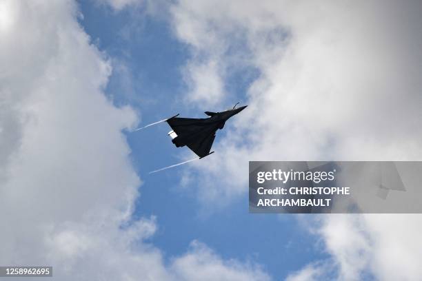 This photograph taken on June 23 shows a Rafale fighter jet performing an exhibition flight demonstration during the International Paris Air Show at...