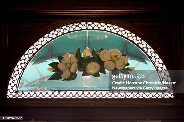 The magnolia designed stained glass hangs above the front doors at the Magnolia Brewery building Monday, Oct. 9 in Houston. The Magnolia Brewery...