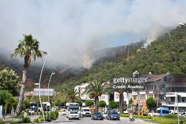 Smoke rises after forest fire broke out in Marmaris district as ground and aerial extinguishing operations continue in Mugla, Turkiye on June 23,...