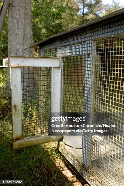 Cage and dog bowl at the abandoned home where some 300 pit bulls were confiscated and the man suspected of being involved with breeding dogs for...