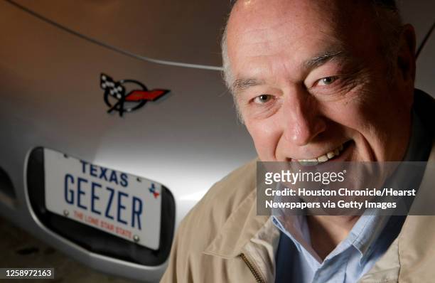 Robert Vienneau poses for a portrait near his Corvette adorned with the vanity license plate GEEZER Friday, Jan. 25 in Houston. GEEZER is a license...