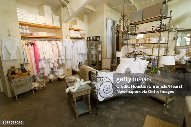 An antique day bed with French embroidered robes and sleepwear is shown in the bedding room of Indulge Maison Decor Friday, Aug. 29 in Houston.