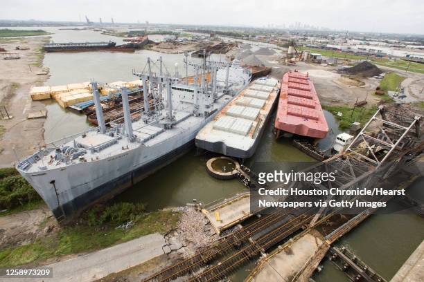 Cargo ship and several barges are stacked up at a railroad bridge along the inner harbor navigation canal off the Industrial Canal that were left in...