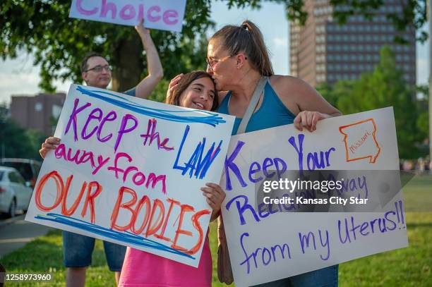 Giuliana Cangelosi left, and her mother Nichole Cangelosi share a moment together while attending a protest opposing the Supreme Court&apos;s ruling...