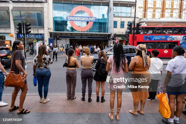 Street scene as people cross the road to and from Brixton underground station in the diverse community of Brixton on 22nd June 2023 in London, United...