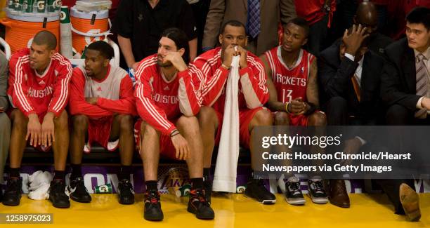 Houston Rockets Shane Battier, Aaron Brooks, Luis Scola, Chuck Hayes, Von Wafer, Dikembe Mutombo and Yao Ming sit on the bench near the end of the...