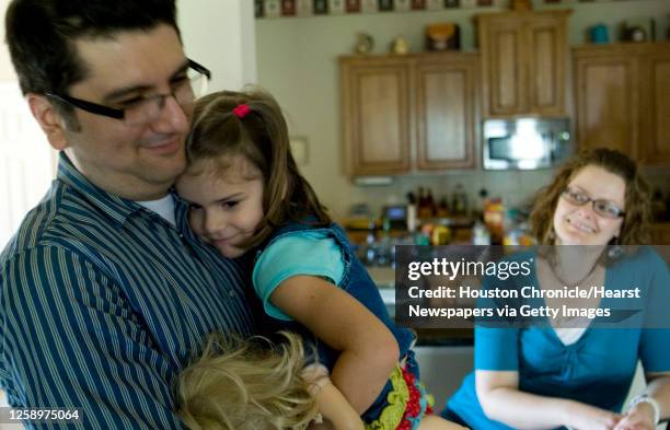 Latin Grammy Award winner and Christian artist Coalo Zamorano embraces his daughter, Rebeca as he wife, Lorena, looks on Tuesday, May 19 in Spring....