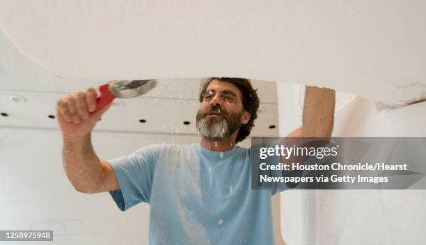 Artist Wayne White shaves Styrofoam as he forms a sculpture dedicated to George Jones at Rice Gallery Friday, Aug. 21 Houston. White, who is well...