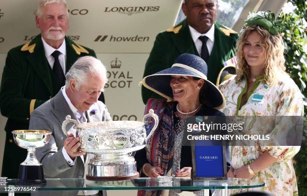 Britain's King Charles III presents the Coronation Stakes trophy to Princess Zahra Aga Khan, after Tahiyra, ridden by Chris Hayes took first place,...