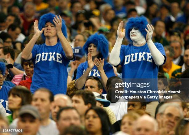 Trio of Duke fans stand and clap at the beginning of the 2010 NCAA South Regional Championship college men's basketball game between Duke and Baylor...