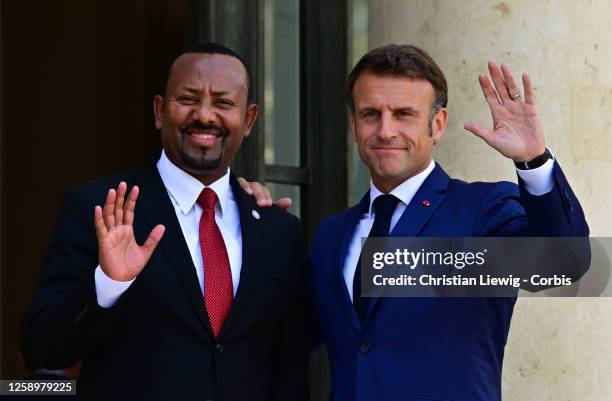 French President Emmanuel Macron escorts Ethiopia's Prime Minister Abiy Ahmed as he leaves at the Elysee Palace, amid the New Global Financial Pact...