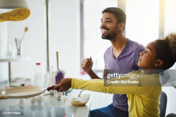 my father taught me to flip the pancake. - making pancakes stock pictures, royalty-free photos & images