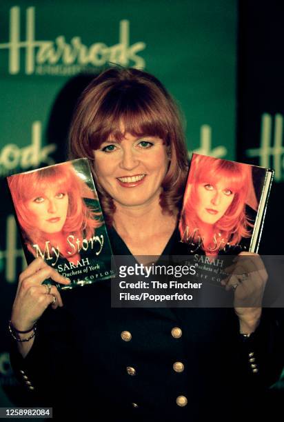 Sarah The Duchess of York holding copies of her biography, "My Story", at Harrods department store in London on 25th November 1996.