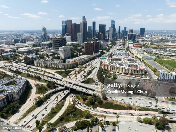 Los Angeles skyline and the four-level interchange where the 110 and 101 freeways meet. Photographed in Los Angeles, CA on Friday, June 23, 2023.