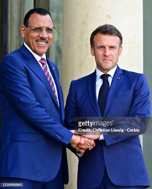 French President Emmanuel Macron greets Niger's President Mohamed Bazoum as he arrives for a meeting at the Elysee Palace, amid the New Global...