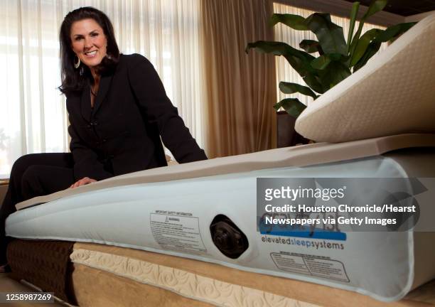 Kelli Minson, CEO of Gravity Solutions Inc., poses for a portrait with a Gravity First Elevated Sleep Solutions mattress Thursday, Oct. 4 in Houston....